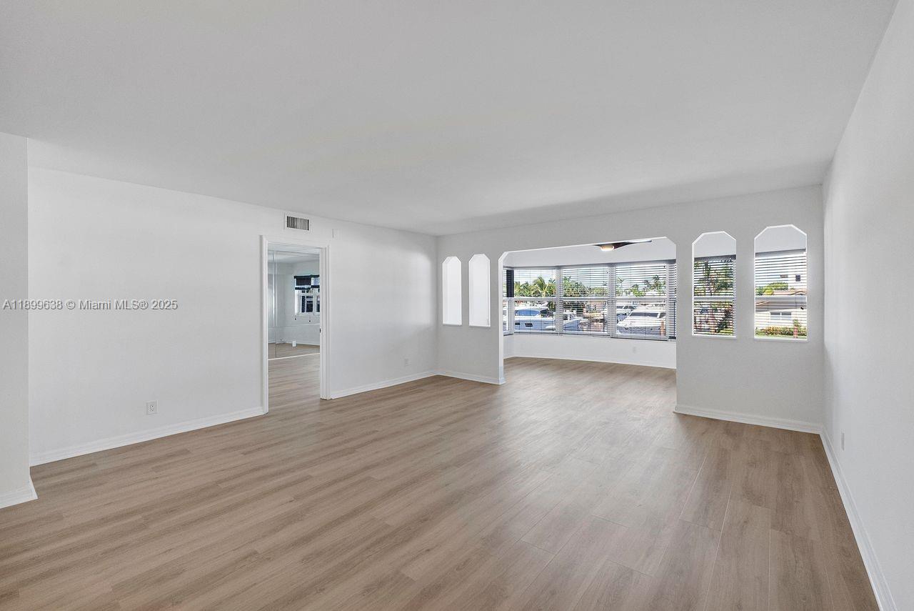 3111 Northeast 51st Street, Unit 202C Fort Lauderdale, FL 33308 - Photo 25 of 46 a view of a room with wooden floor