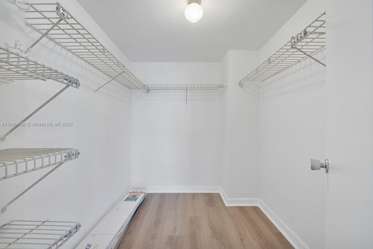 3111 Northeast 51st Street, Unit 202C Fort Lauderdale, FL 33308 - Photo 29 of 46 a view of a room with racks on the wall