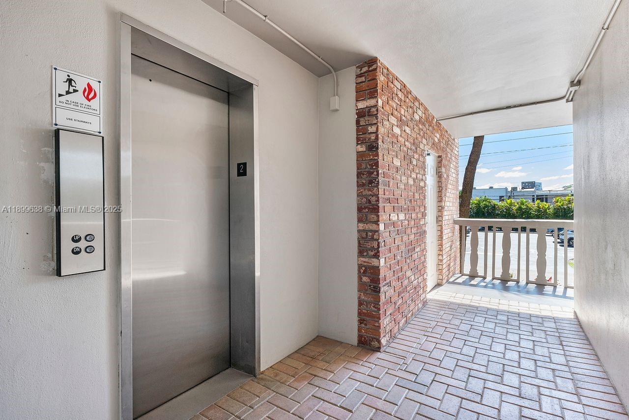 3111 Northeast 51st Street, Unit 202C Fort Lauderdale, FL 33308 - Photo 33 of 46 a view of a hallway with wooden floor and a bathroom