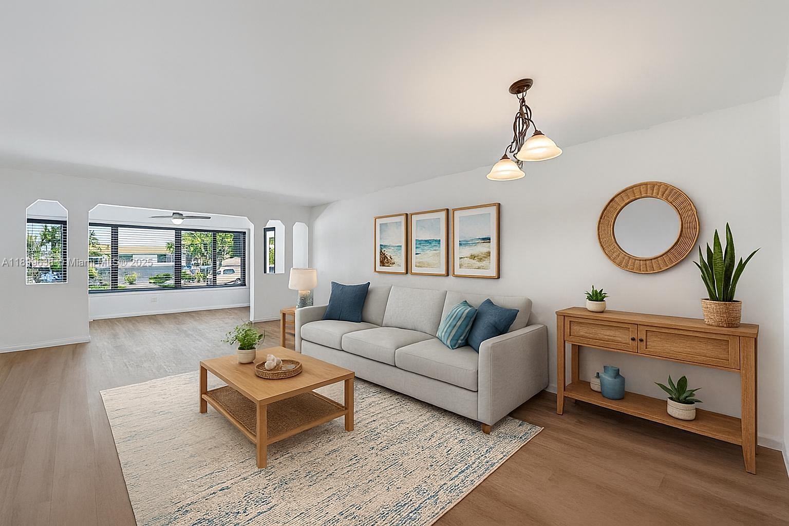 3111 Northeast 51st Street, Unit 202C Fort Lauderdale, FL 33308 - Photo 4 of 46 a living room with furniture a rug and a window