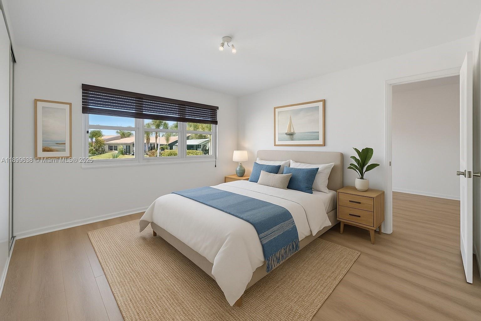 3111 Northeast 51st Street, Unit 202C Fort Lauderdale, FL 33308 - Photo 5 of 46 a spacious bedroom with a large bed and a window