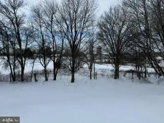 a view of white house with a snow and trees