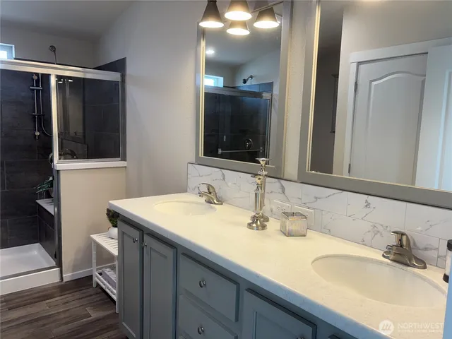 a bathroom with a shower and a sink