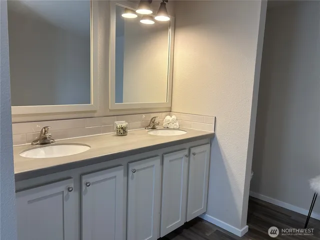 a bathroom with a bathtub and a chair