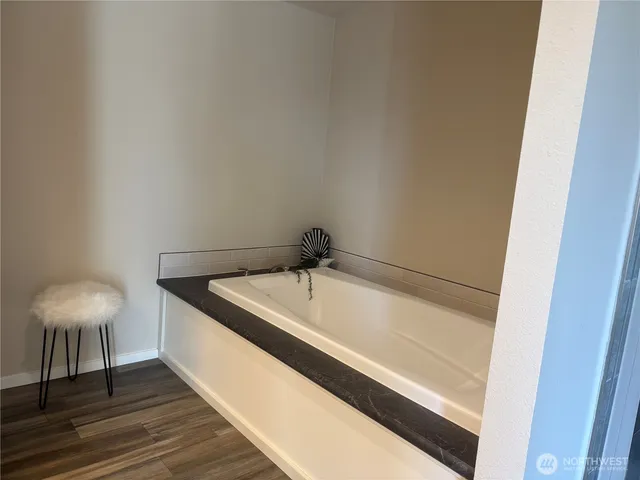 a bathroom with a shower and a tub
