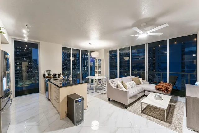 a living room with furniture large window and outer view