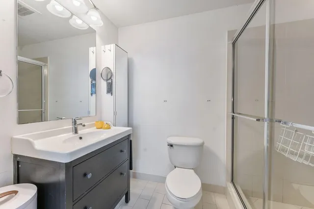 a bathroom with a sink a large mirror and a bathtub