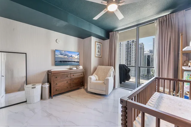 a bedroom with a bed and a ceiling fan