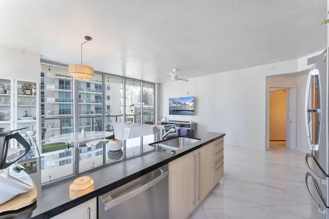 a kitchen with counter top space and windows