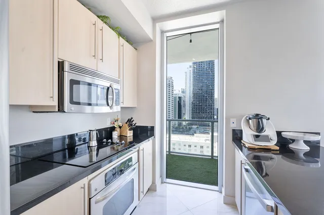 a kitchen with granite countertop a sink stove and cabinets