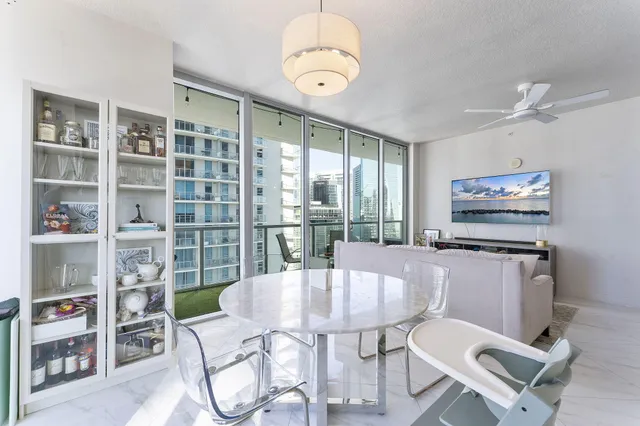 a table and chairs in a room with a bookshelf