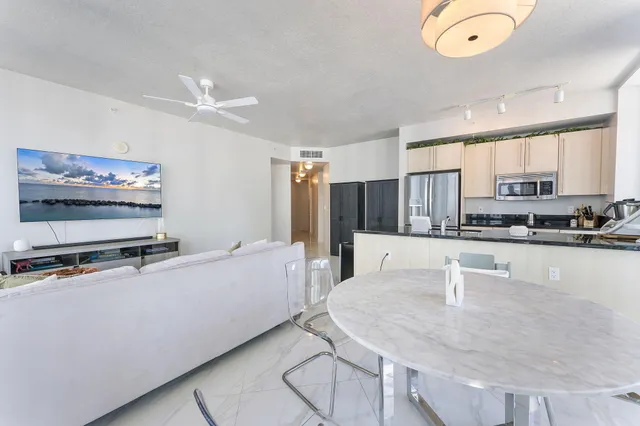 a kitchen with stainless steel appliances granite countertop a sink a stove and a refrigerator