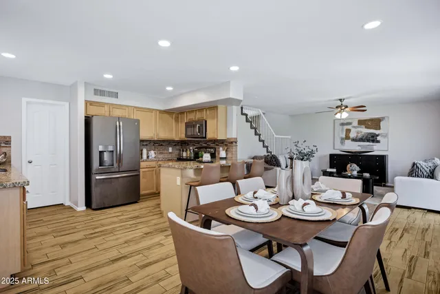 a kitchen with a sink refrigerator and cabinets