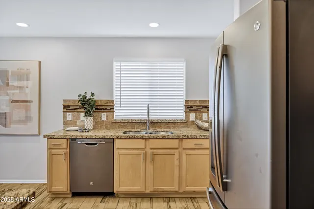 a kitchen with granite countertop kitchen island sink stove and granite counter top