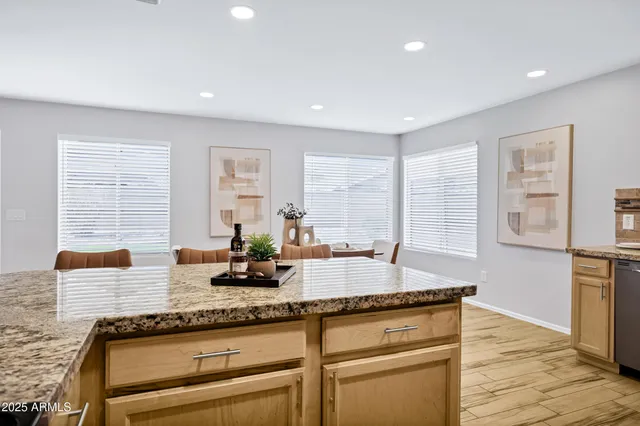 a kitchen that has a table and chairs in it