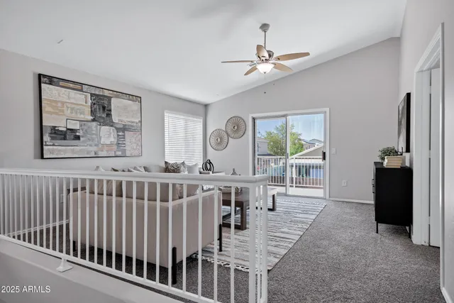 a living room with furniture a ceiling fan and a window