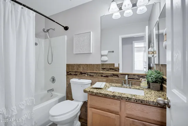 a bedroom with a bed and a ceiling fan