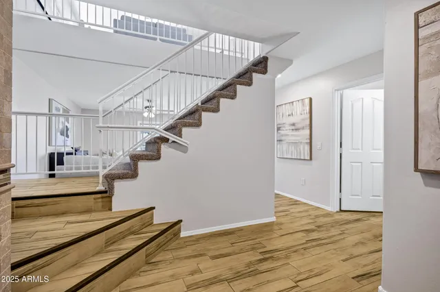 a view of entryway and hall with wooden floor