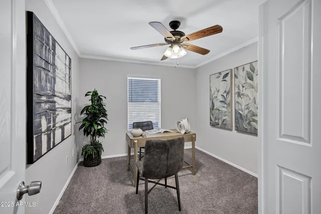 a view of a workspace with furniture and a window