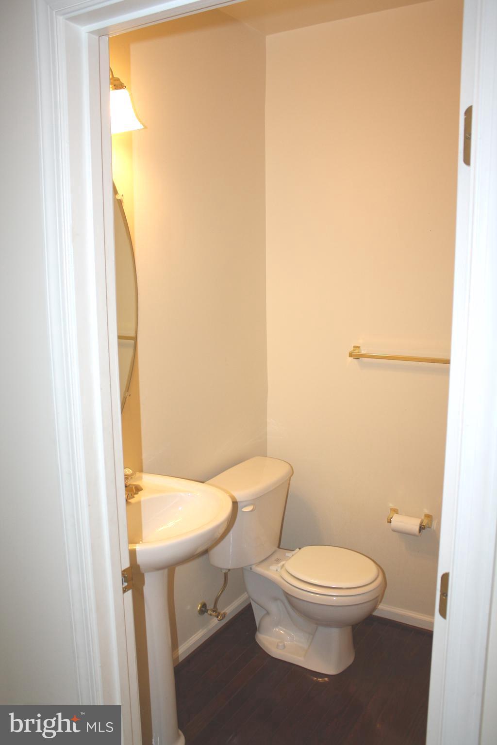 8378 Tillett Loop Manassas, VA 20110 - Photo 13 of 24 a white toilet sitting next to a small sink