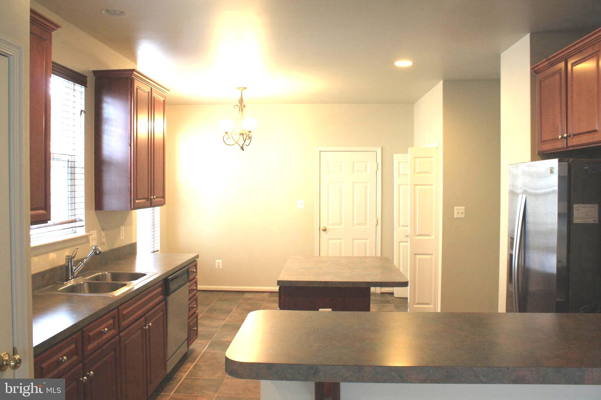 8378 Tillett Loop Manassas, VA 20110 - Photo 4 of 24 a view of kitchen with stainless steel appliances granite countertop a sink and a refrigerator