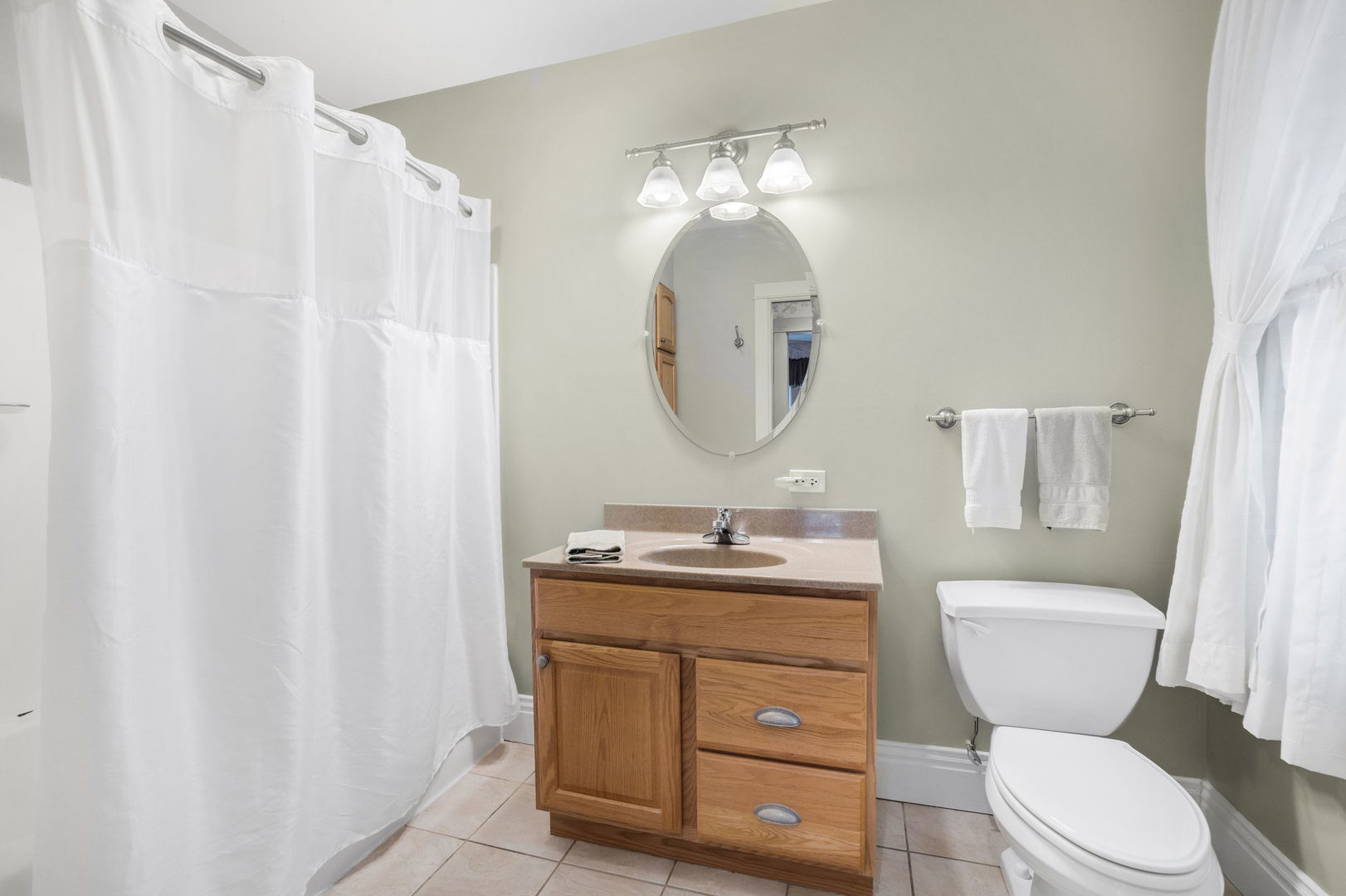 618 Woodward Street Beecher, IL 60401 - Photo 16 of 23 a bathroom with a toilet a sink and a mirror
