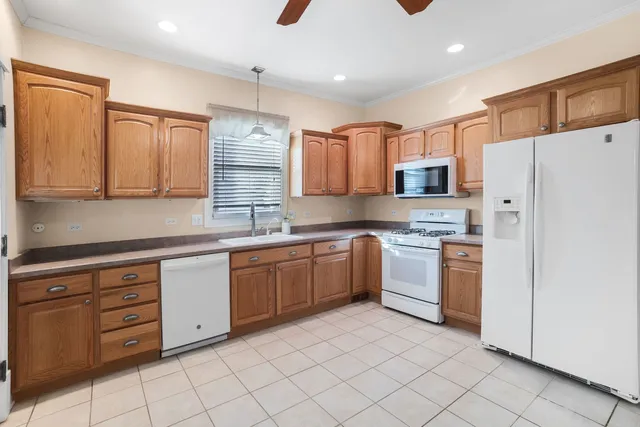 a kitchen with stainless steel appliances granite countertop a refrigerator and a stove top oven