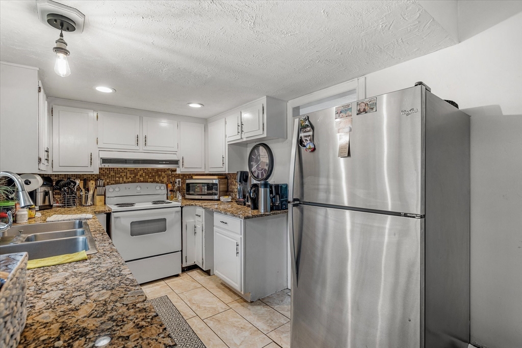 240 Worcester Road Barre, MA 01005 - Photo 20 of 38 a kitchen with a refrigerator sink and cabinets