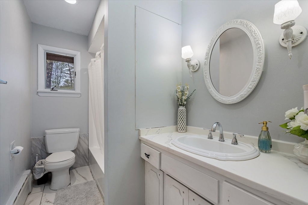 240 Worcester Road Barre, MA 01005 - Photo 26 of 38 a bathroom with a toilet sink and mirror