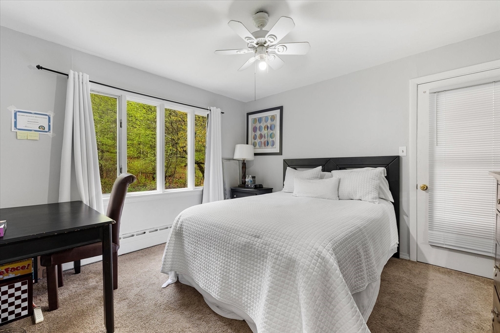 240 Worcester Road Barre, MA 01005 - Photo 27 of 38 a bedroom with a large bed and a table