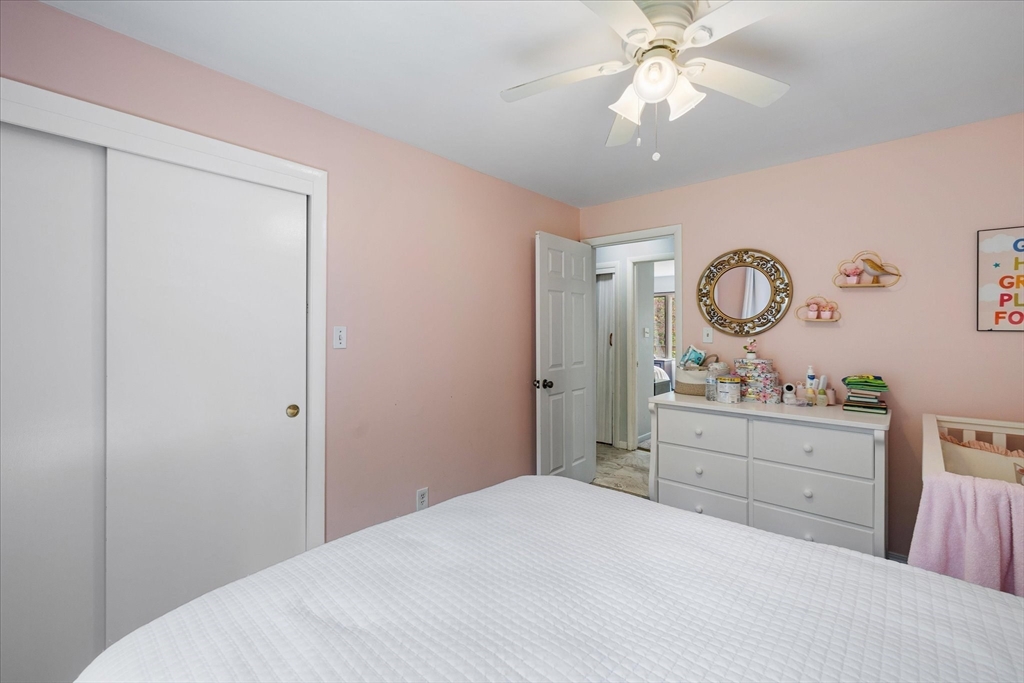 240 Worcester Road Barre, MA 01005 - Photo 30 of 38 a bedroom with a bed and a chandelier