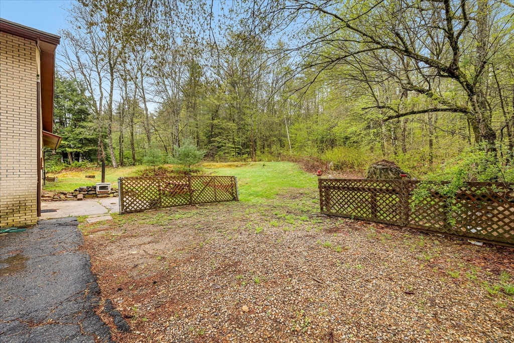 240 Worcester Road Barre, MA 01005 - Photo 6 of 38 a backyard of a house with table and chairs