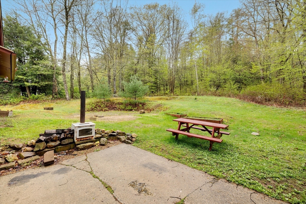 240 Worcester Road Barre, MA 01005 - Photo 7 of 38 a backyard of a house with table and chairs