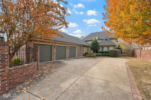 a front view of a house with yard and tree