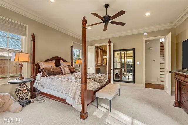 a bedroom with a bed mirror and window