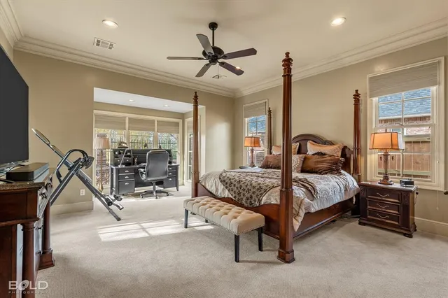 a bedroom with a bed gym equipment and a large window