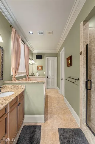 a bathroom with a granite countertop sink a mirror and a shower