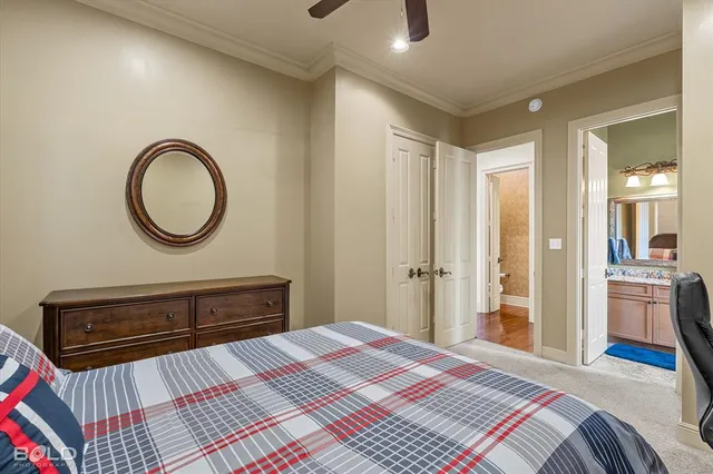 a bedroom with a bed and a dresser with mirror