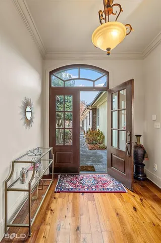 a bedroom with furniture and a large window
