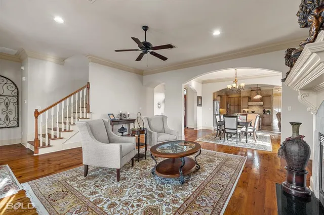 a living room with furniture and a chandelier