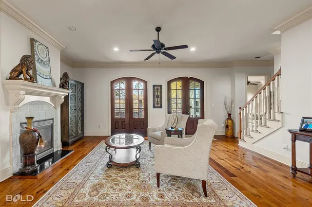 a view of a livingroom with furniture a fireplace and wooden floor