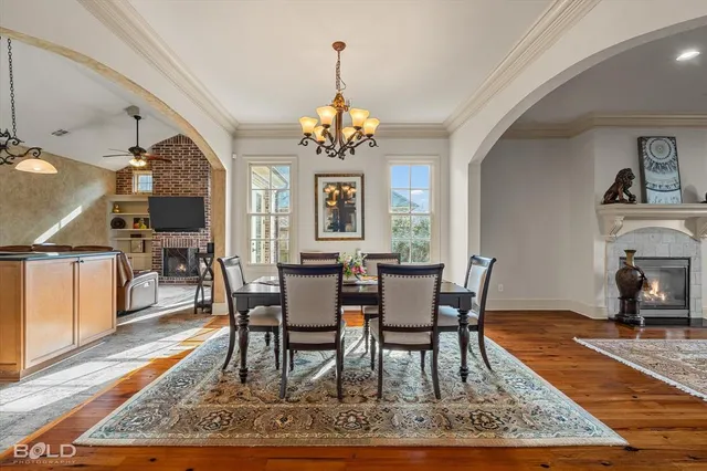 a view of a dining room with furniture a rug and wooden floor