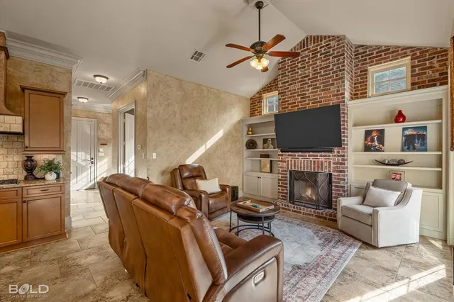 a living room with furniture a flat screen tv and a fireplace