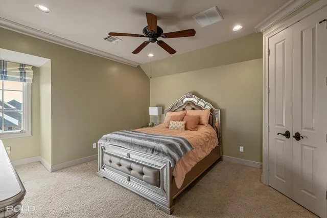 a bed room with a bed and a ceiling fan