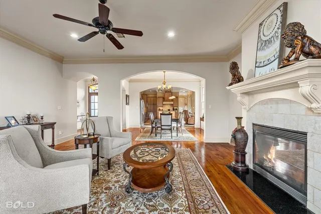 a living room with furniture a fireplace and a chandelier