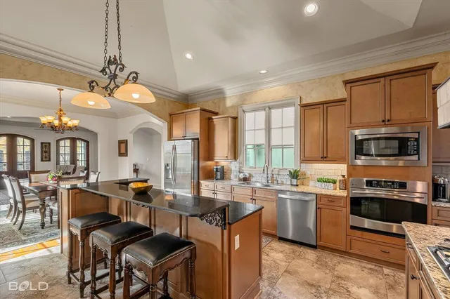 a kitchen with lots of counter top space appliances and furniture