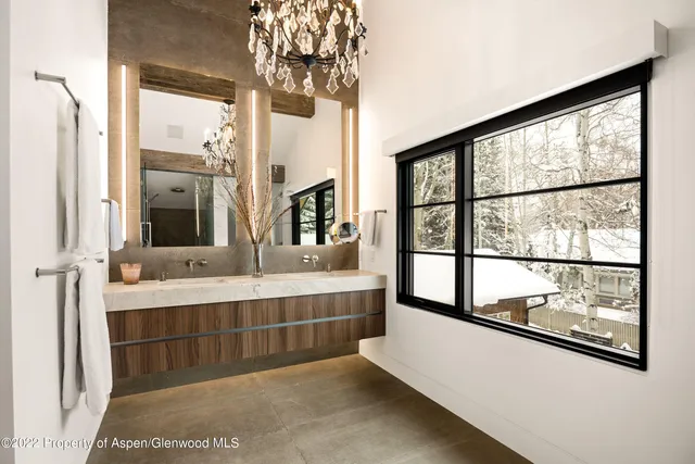 a bathroom with a double vanity sink and a large mirror