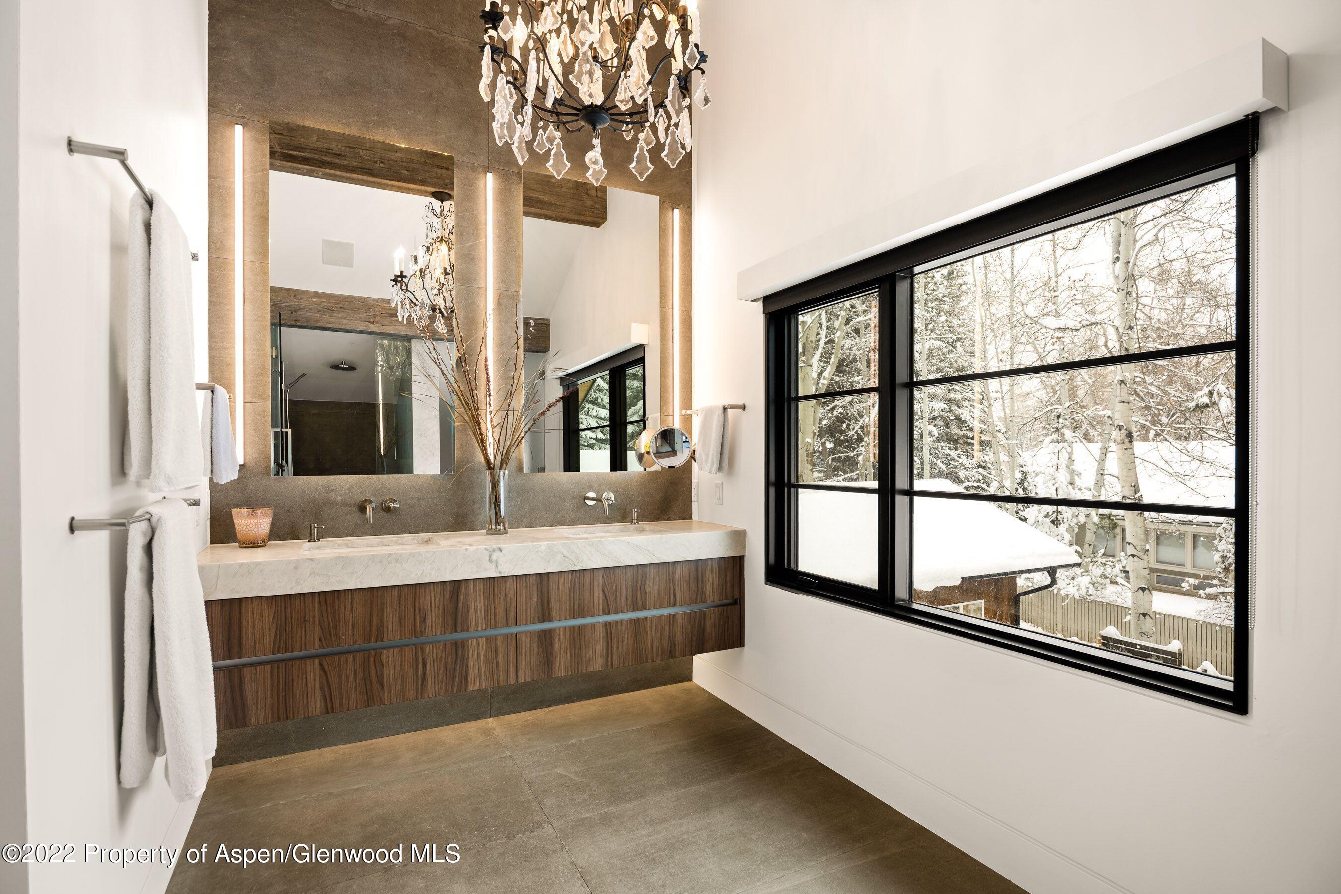 503 North 4th Street Aspen, CO 81611 - Photo 11 of 21 a bathroom with a double vanity sink and a large mirror