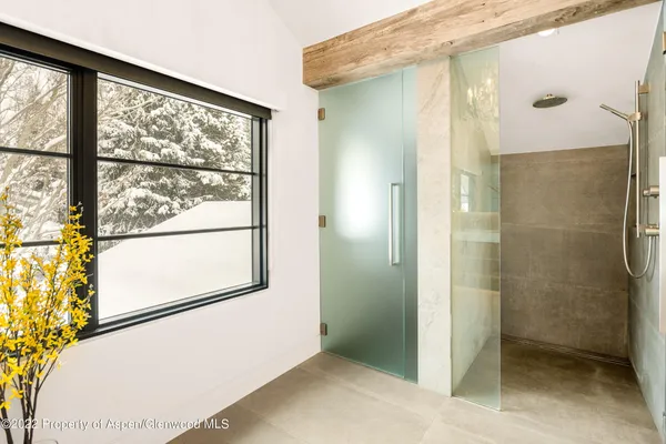 a bathroom with a glass shower door