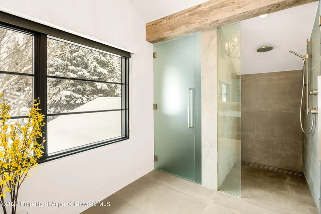 a bathroom with a glass shower door